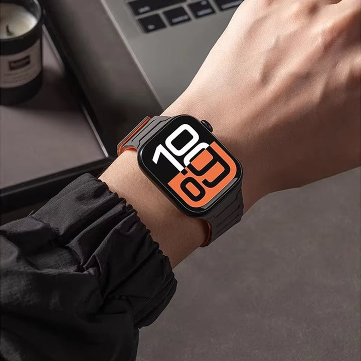 Versatile men's blue silicone Apple Watch band with magnetic clasp, suitable for sport or casual wear.
