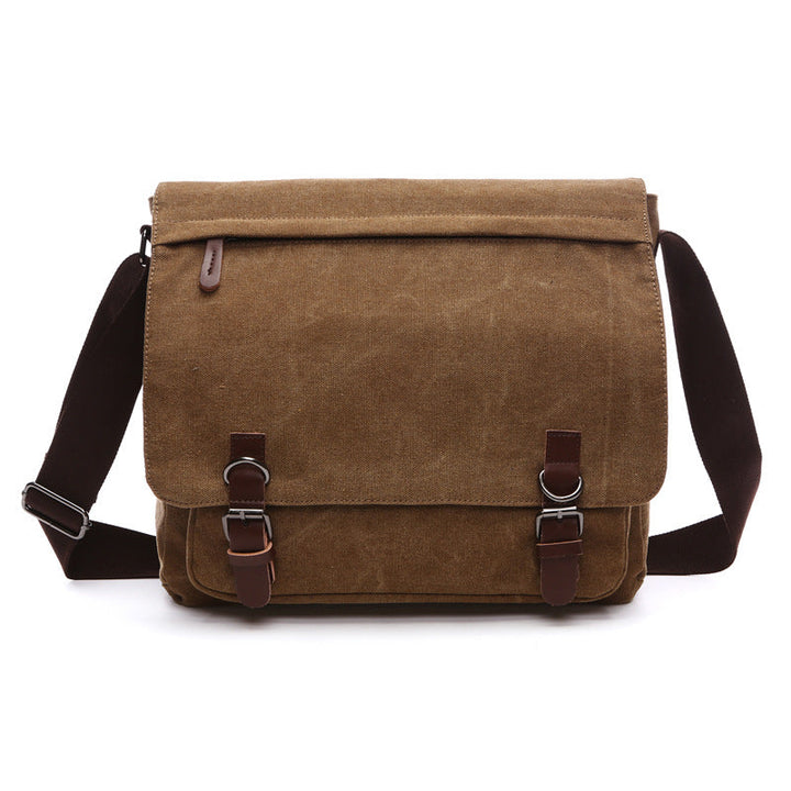Classic men's canvas shoulder bag with secure buckle straps. Great for work, travel, or everyday carry.
