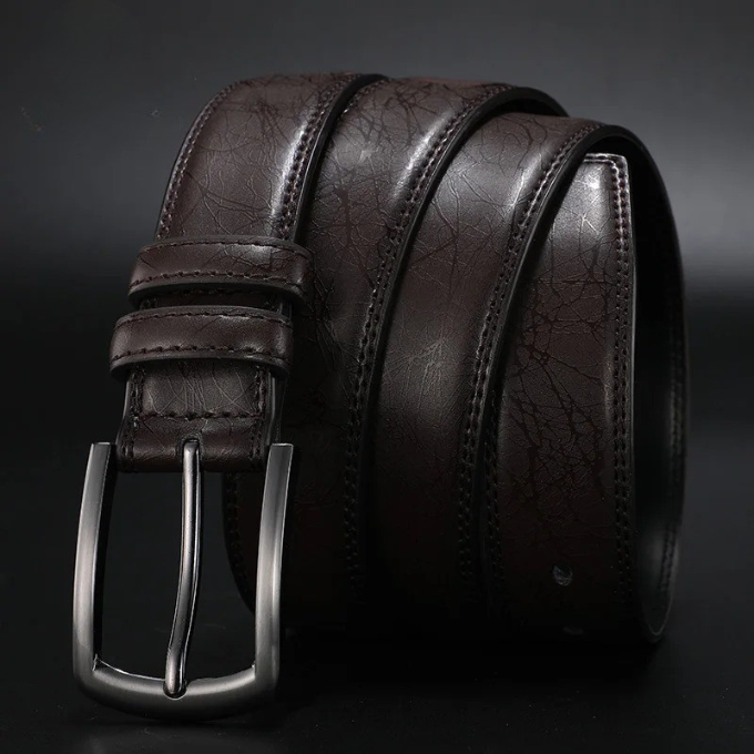 Stylish men's fashion accessory: a durable leather belt with a striking gunmetal buckle, ideal for casual outfits.