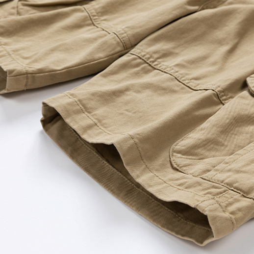 Flat lay: collection of men's cargo shorts in khaki, green, navy, and black, showcasing color options.