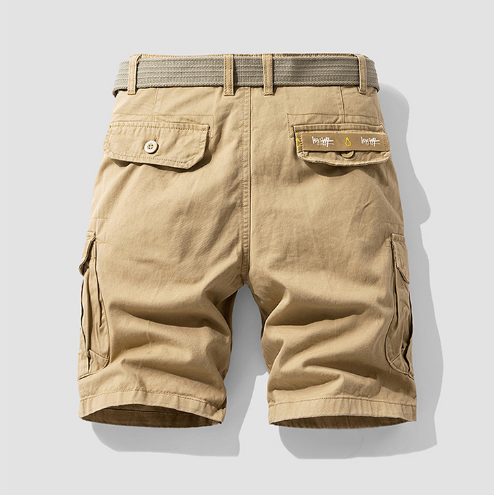 Rugged green men's cargo shorts with utility pockets, ideal for hiking, travel & everyday comfort.