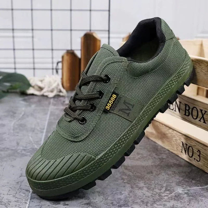 Close-up of durable green urban camo pattern on men's tactical all-terrain adventure sneakers.
