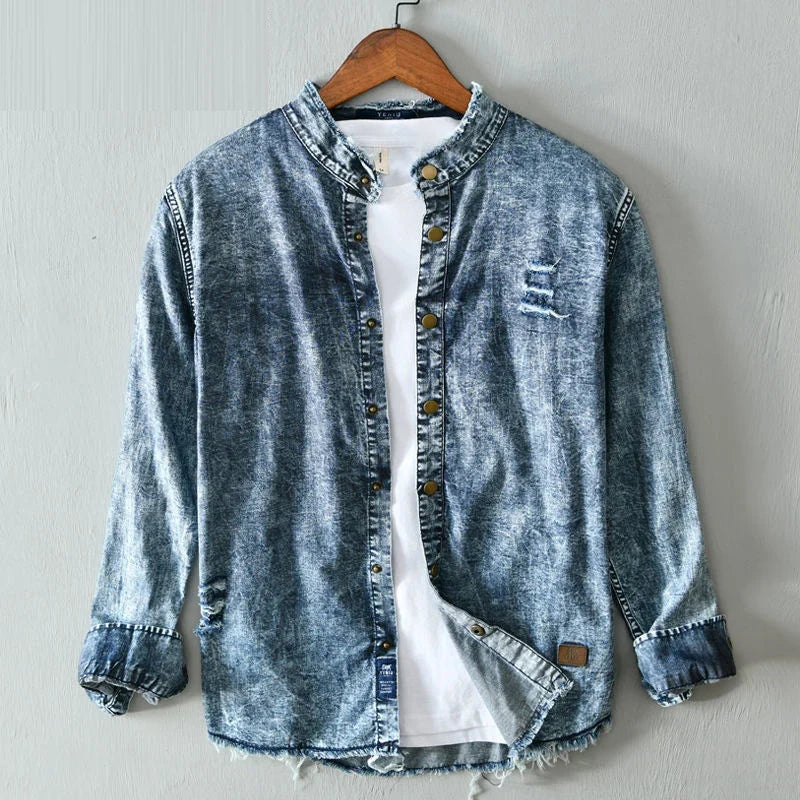 Men's edgy blue denim shirt with raw hems, collarless design. Modern fit, long sleeve, casual street style.