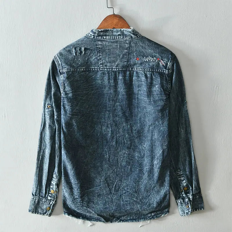 Stylish men's light blue denim shirt. Edgy raw hem, sharp collarless cut, distressed details for fashion.