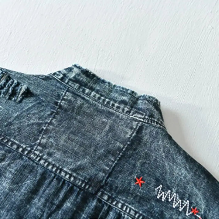 Distressed men's denim shirt. Edgy collarless, raw hem, light blue. Modern fit for fashion-forward men.