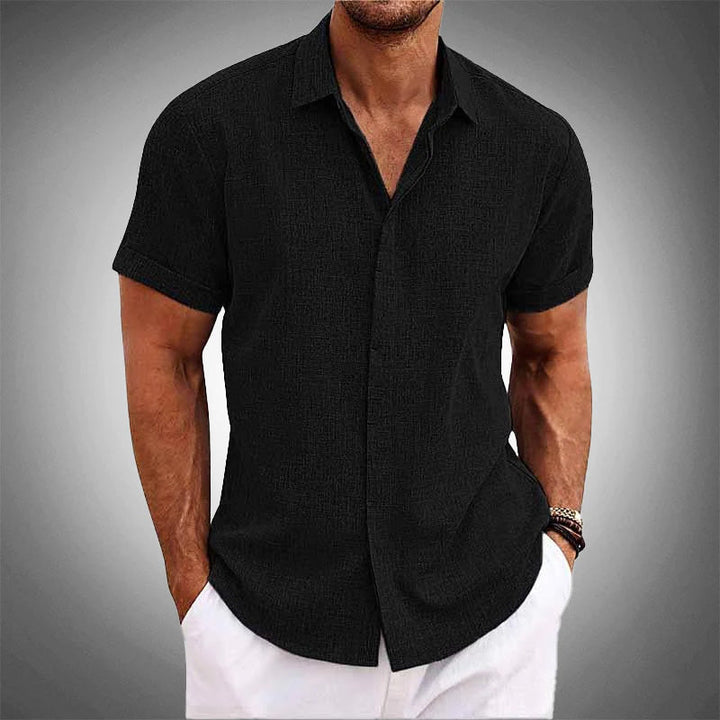 Stylish men's black short-sleeve shirt. Effortless, cool & wrinkle-free for versatile summer fashion.