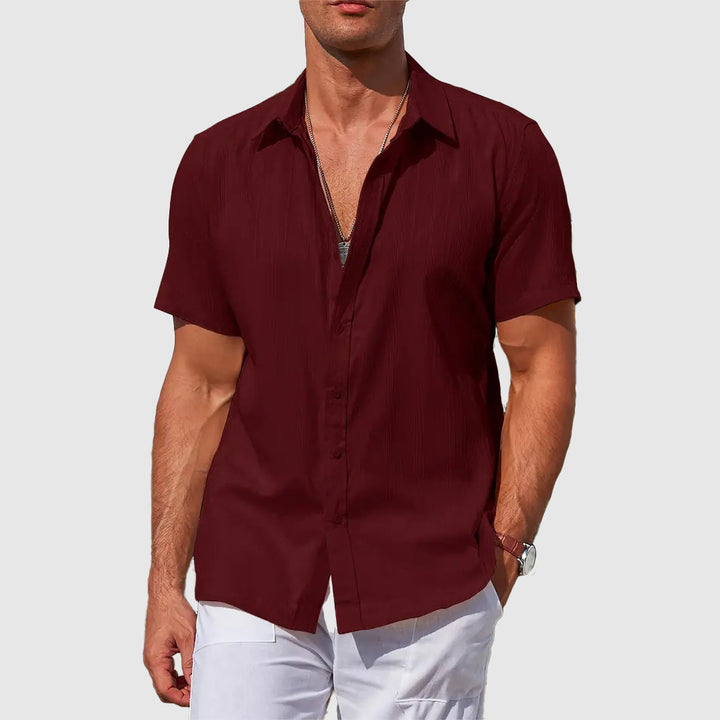 Detail of men's short-sleeve summer shirt. Relaxed fit fabric for casual wear, comfort, and everyday style.
