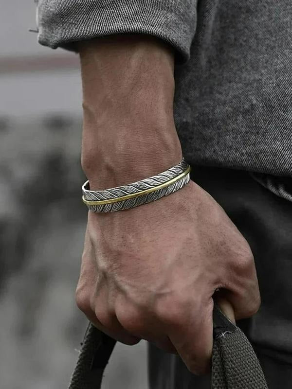 Modern men's feather cuff bracelet featuring intricate silver & gold mixed metal design, a unique piece of men's jewelry.