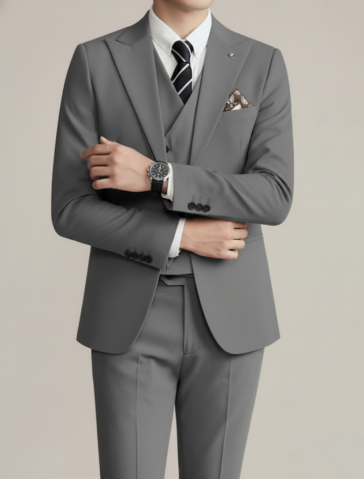 Man confidently posing in a sleek, elegant three-piece suit, ideal for formal occasions and men's fashion.