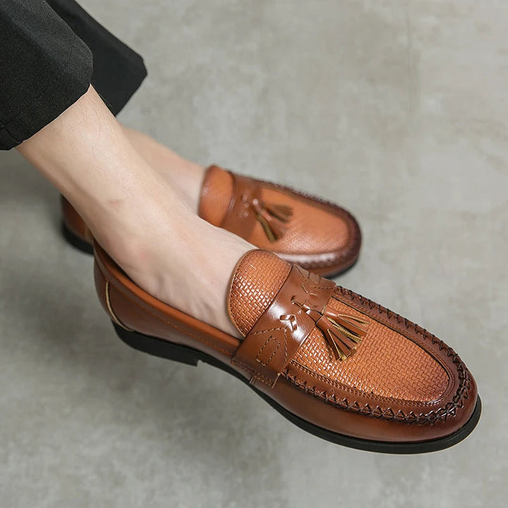 Textured woven men's tassel loafers. Sophisticated slip-on shoes blending comfort and classic style.