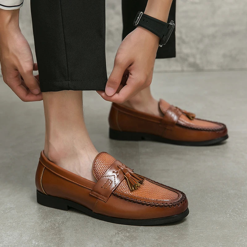 Elegant men's woven loafers featuring decorative tassels. Comfortable slip-on footwear for dressy or casual style.
