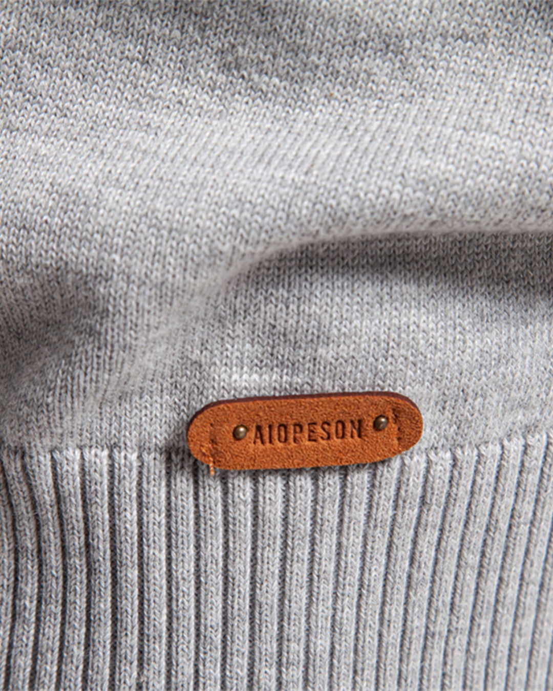Detail of the rib-knit cuffs on the men's elevated textured crewneck sweater.