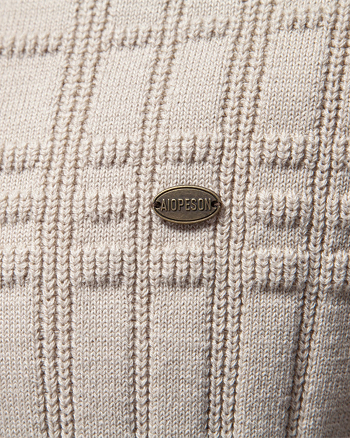 Close-up on the hem of the men's elevated textured knit crewneck sweater.