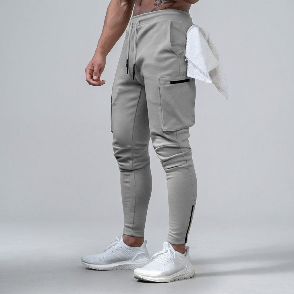 Close-up of men's tapered fit gym pants, showing stretch fabric detail and Ernest branding