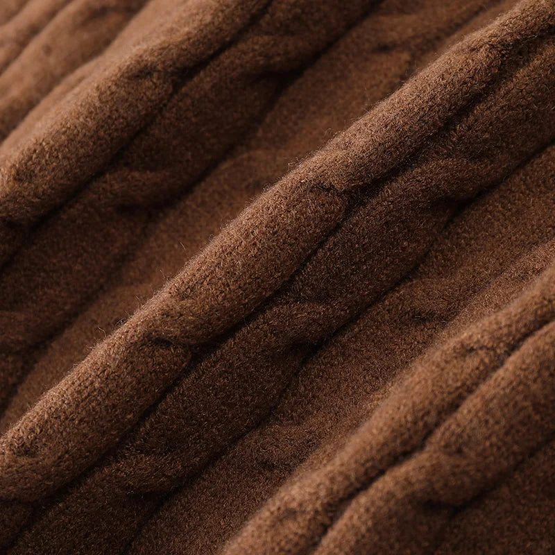 Formal men's knit Everett cardigan, buttoned up, layered over a collared shirt for a smart, versatile look.