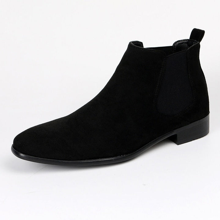 Confident men's brown Chelsea boots, durable, comfortable, & stylish for everyday casual or work.
