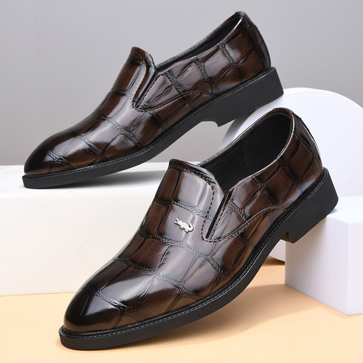 Front view of men's executive slip-on loafers, sleek black leather, classic design for sharp style.