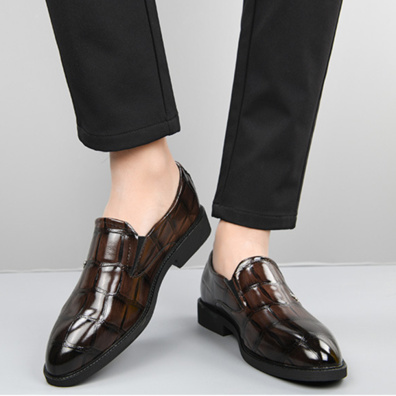 Side profile of men's black leather executive slip-on loafers, elegant and professional dress shoes.