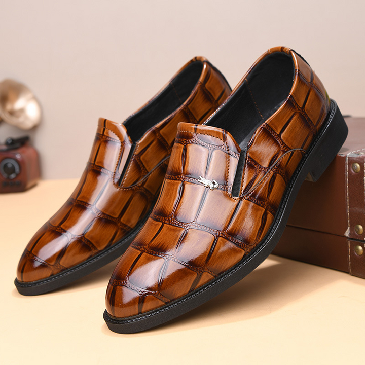 Smooth black leather men's slip-on executive loafers, polished finish, suitable for any formal event.