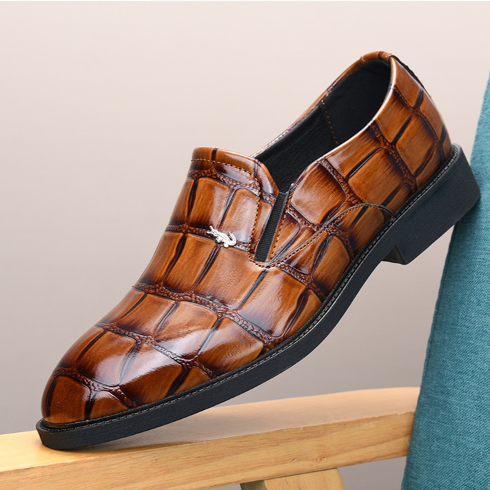 Detail of stitching on men's black slip-on loafers, executive style dress shoes for professional wear.