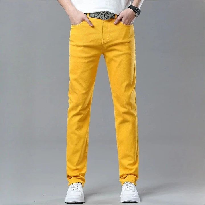 Man wearing red Fireline stretch denim statement trousers, showcasing bold style and comfort.