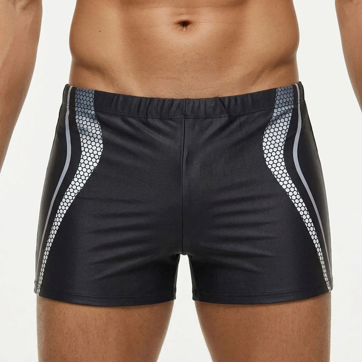 Black men's fitted swim trunks with an elastic waistband, engineered for maximum performance and durability in water.