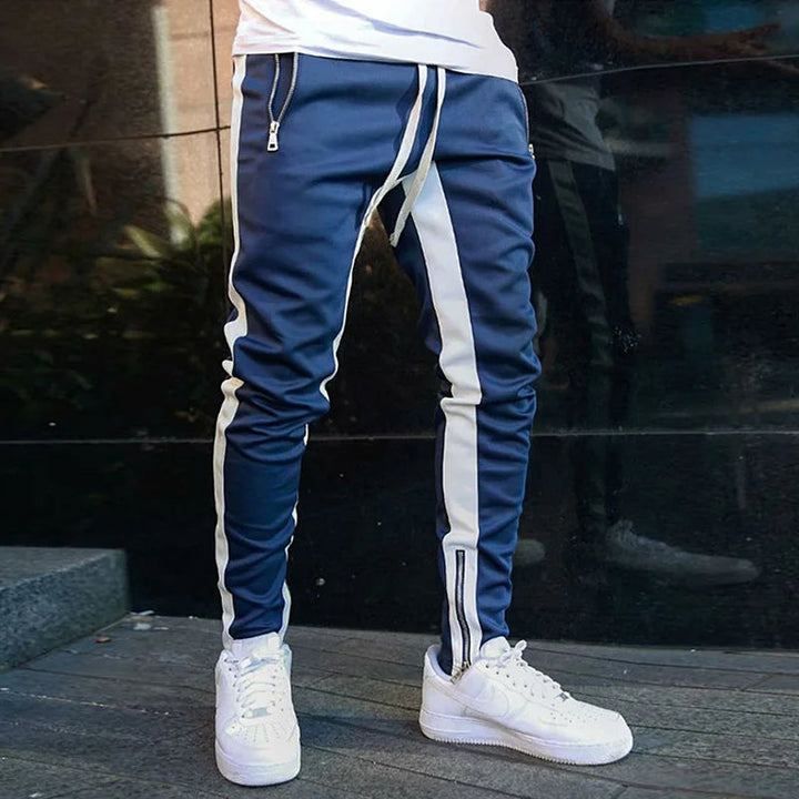 Athletic men's sweatpants with stretch fabric and zippered pockets for gym or leisure.