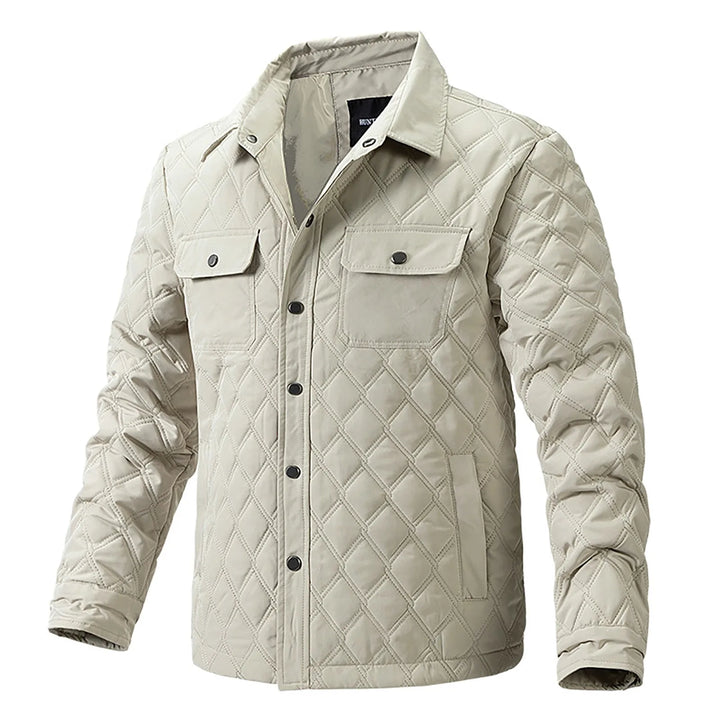 Durable men's quilted jacket, ideal for outdoor wear, with snap closure for utility.