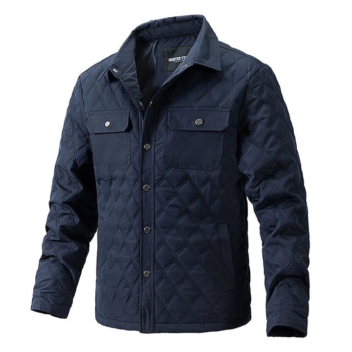 Men's Forge quilted jacket with practical chest pockets & stylish snap closure, perfect for outdoor adventures.