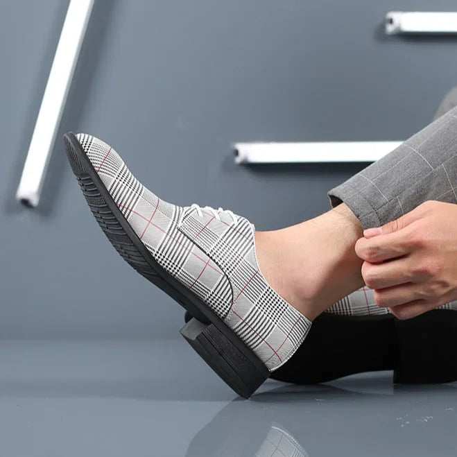 Statement men's dress shoes: black leather & plaid accent. Ideal for formal events & business wear.