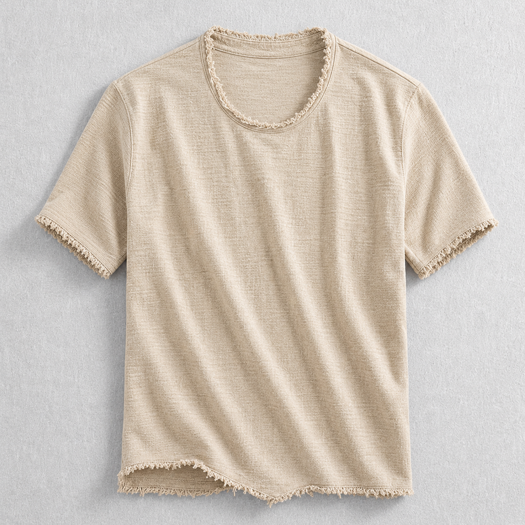 Close-up of modern men's frayed edge cotton blend t-shirt hem, highlighting unique casual style and comfortable fabric.
