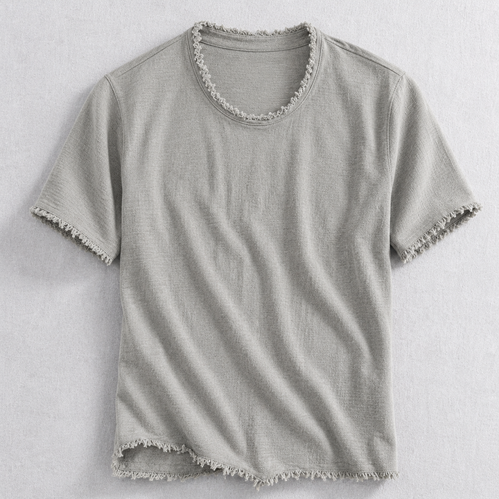 Stylish man wearing a comfortable gray frayed edge cotton blend t-shirt, ideal for modern casual wear.