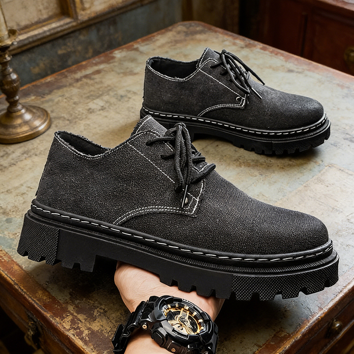 Close-up of men's frayed blue denim shoes, showcasing texture for effortless summer style.