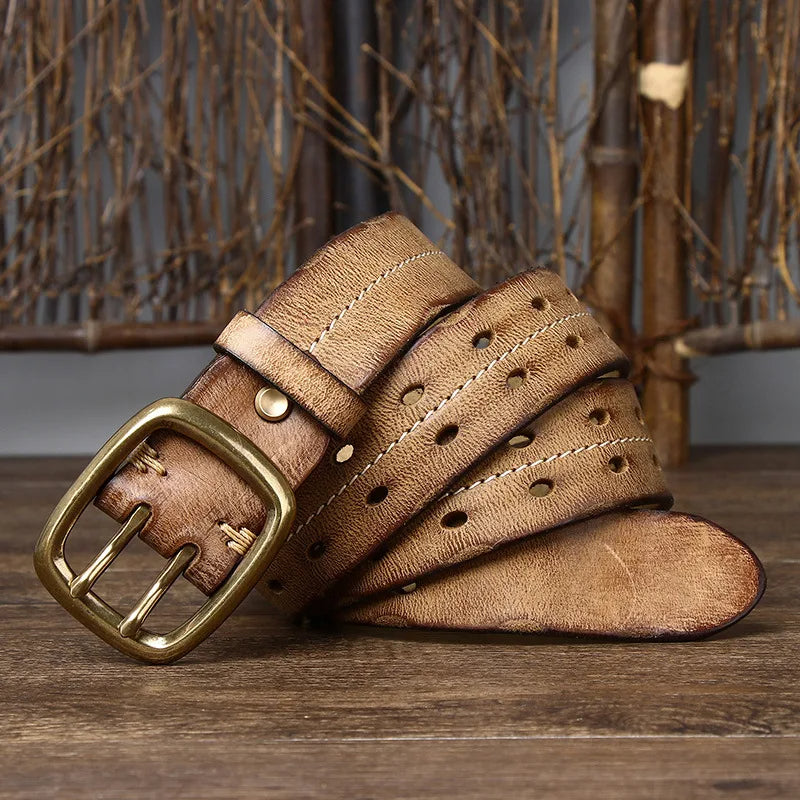 Detail shot of a men's full-grain leather belt showcasing the solid brass buckle and fine leather craftsmanship.