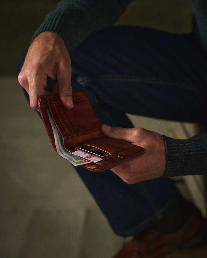 Closed classic black full-grain leather wallet for men with sleek dual closure. Durable design.