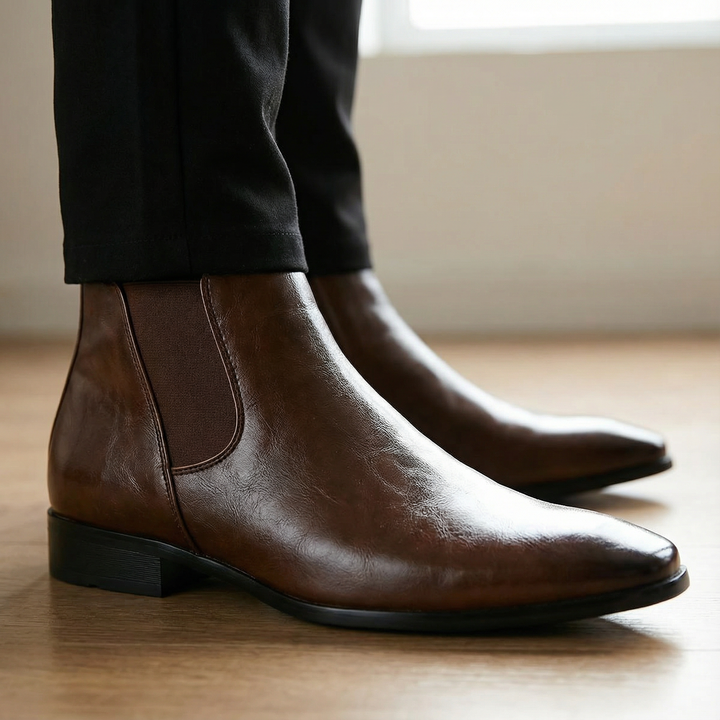 Black full-grain leather Chelsea boots for men, offering durable and classic fashion.