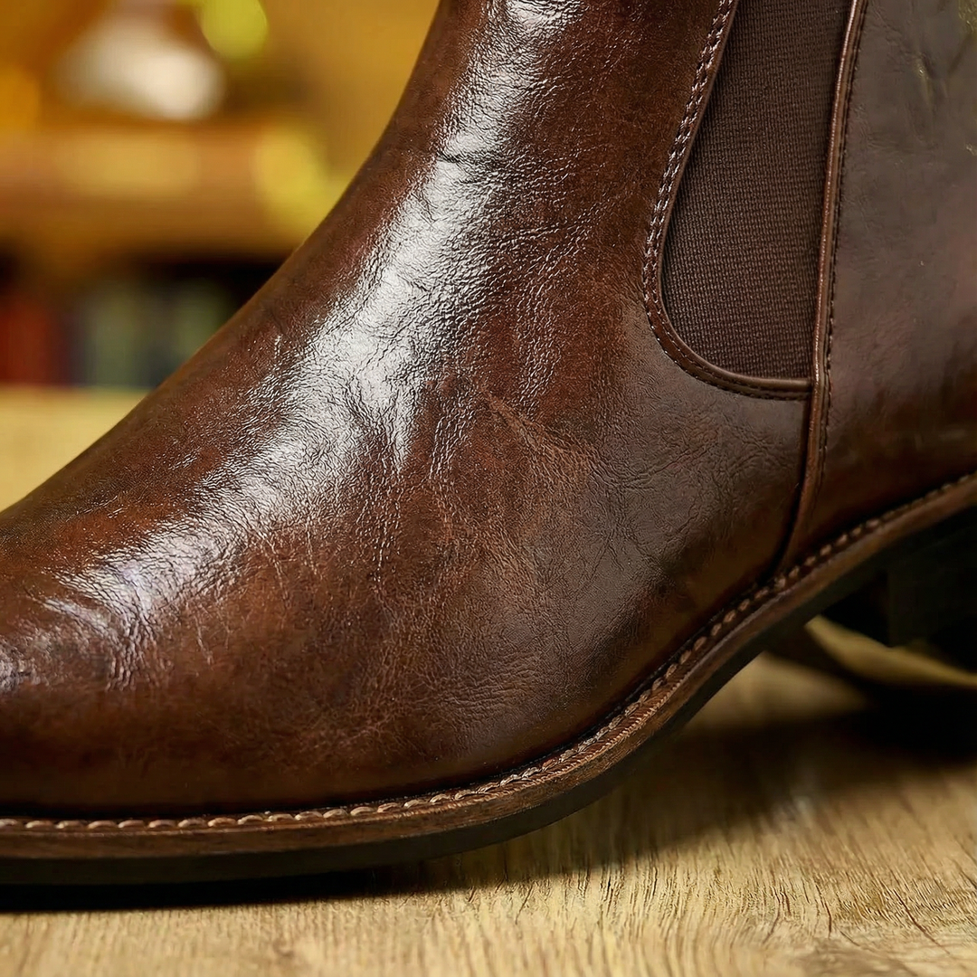 Classic men's brown full-grain leather Chelsea boots, featuring a sleek slip-on design.