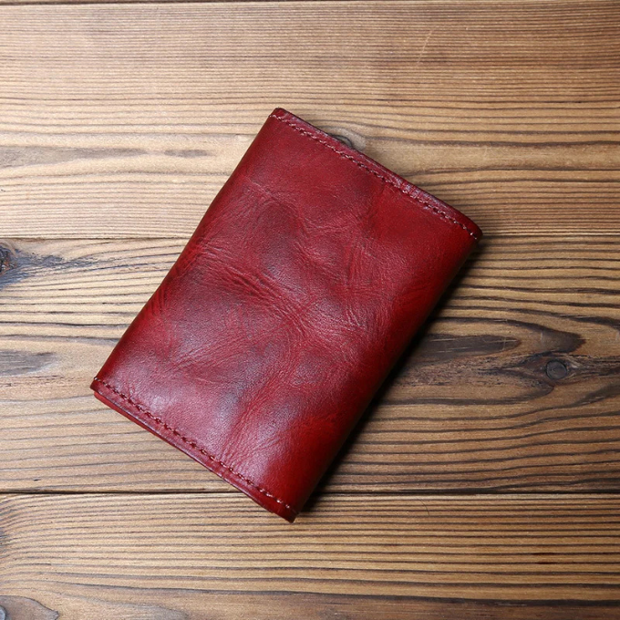 Men's full-grain leather tri-fold wallet. Durable, aged cowhide with convenient snap closure.