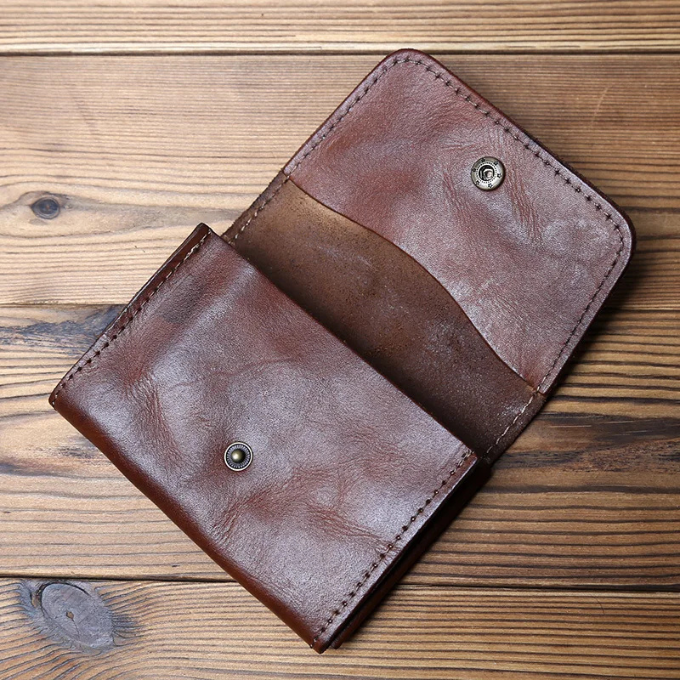 Durable tri-fold leather wallet for men, full-grain cowhide with secure snap closure.