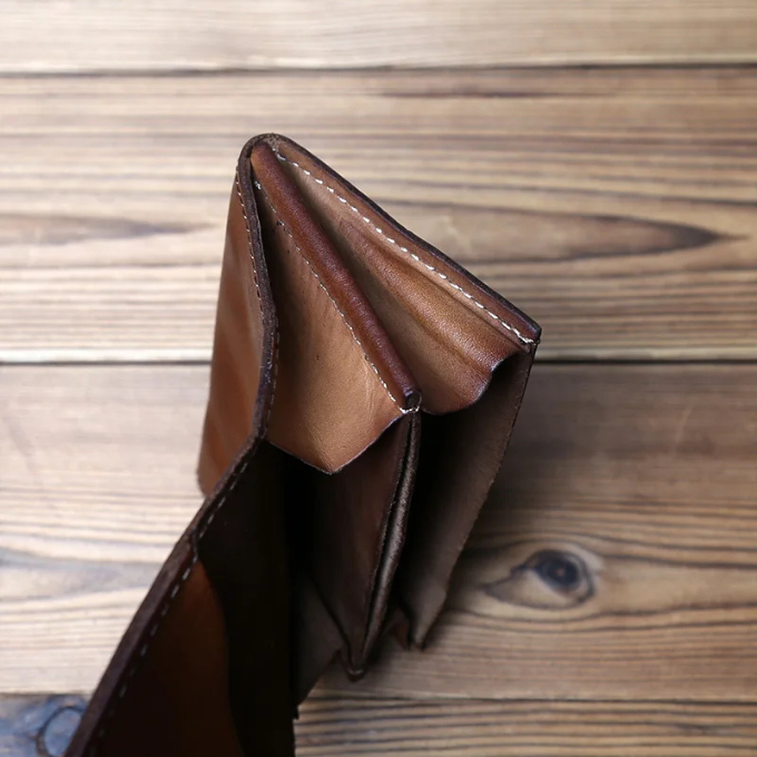 Aged full-grain leather men's tri-fold wallet. Secure snap closure, a durable everyday accessory.