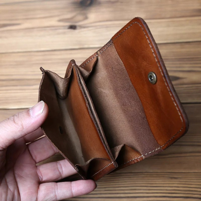 High-quality men's full-grain leather wallet. Tri-fold design with snap closure, built to last.