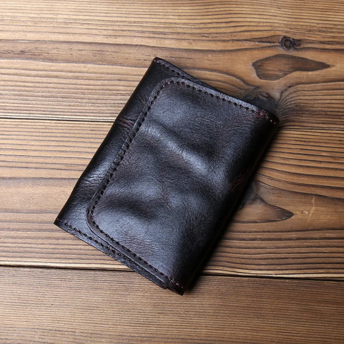 Everyday carry men's wallet: full-grain cowhide leather, tri-fold design, and snap closure.