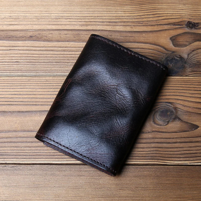 Classic men's tri-fold wallet made from durable full-grain leather with a secure snap.