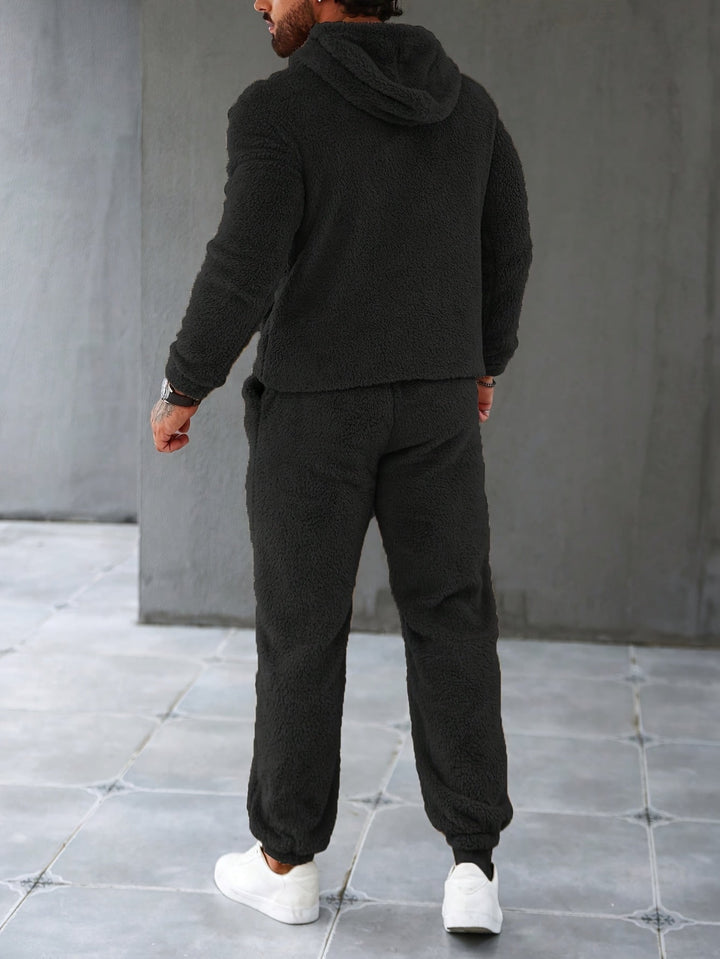 Stylish men's fleece hoodie and jogger set in dark green, designed for cozy comfort & winter warmth.