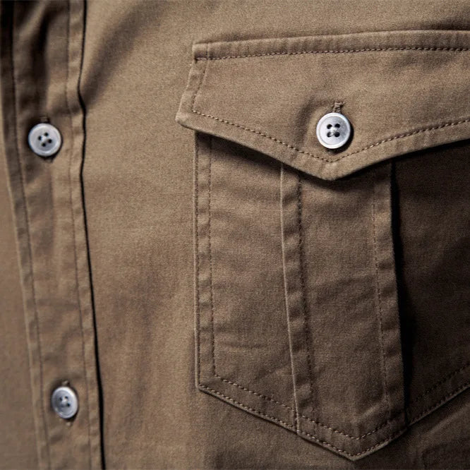 Man with rolled sleeves on a Garrison utility shirt. Comfortable, long sleeve button-down for everyday & workwear.