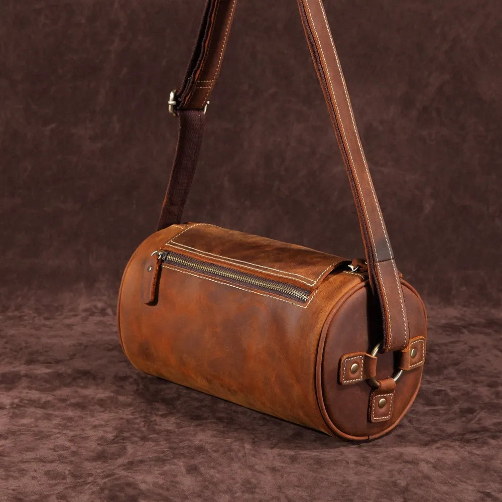 Front view of men's genuine leather messenger bag, coffee brown, with flap & buckle details.