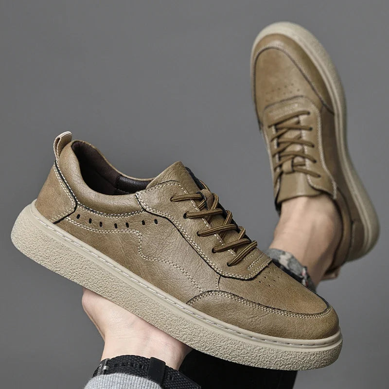 Close-up of men's genuine leather perforated sneakers, highlighting the texture and breathable design.