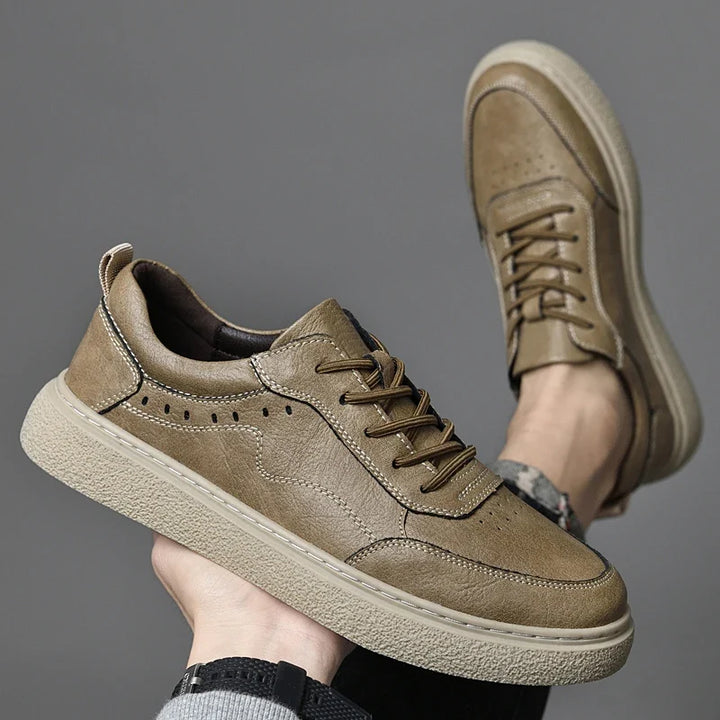 Close-up of men's genuine leather perforated sneakers, highlighting the texture and breathable design.