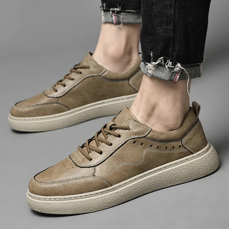 Side view of men's stylish genuine leather perforated sneakers with a clean, minimalist design and white sole.