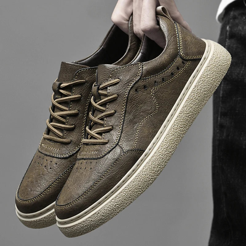Front view of comfortable men's perforated leather sneakers, showcasing the casual, minimalist footwear design.